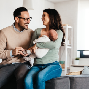 parents with their child and happy to have their baby home before they notice sign of birth injury