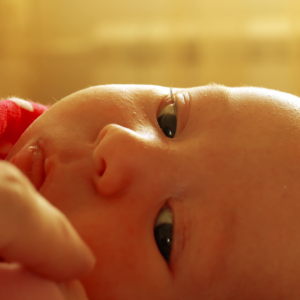 baby who has suffered a neonatal stroke looking at mom