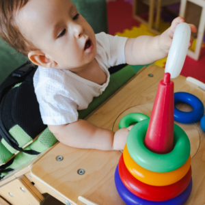 child with birth injury playing in therapy