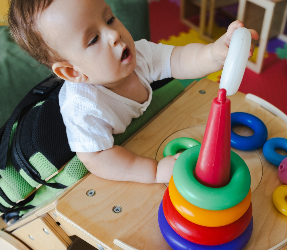 child with birth injury playing in therapy