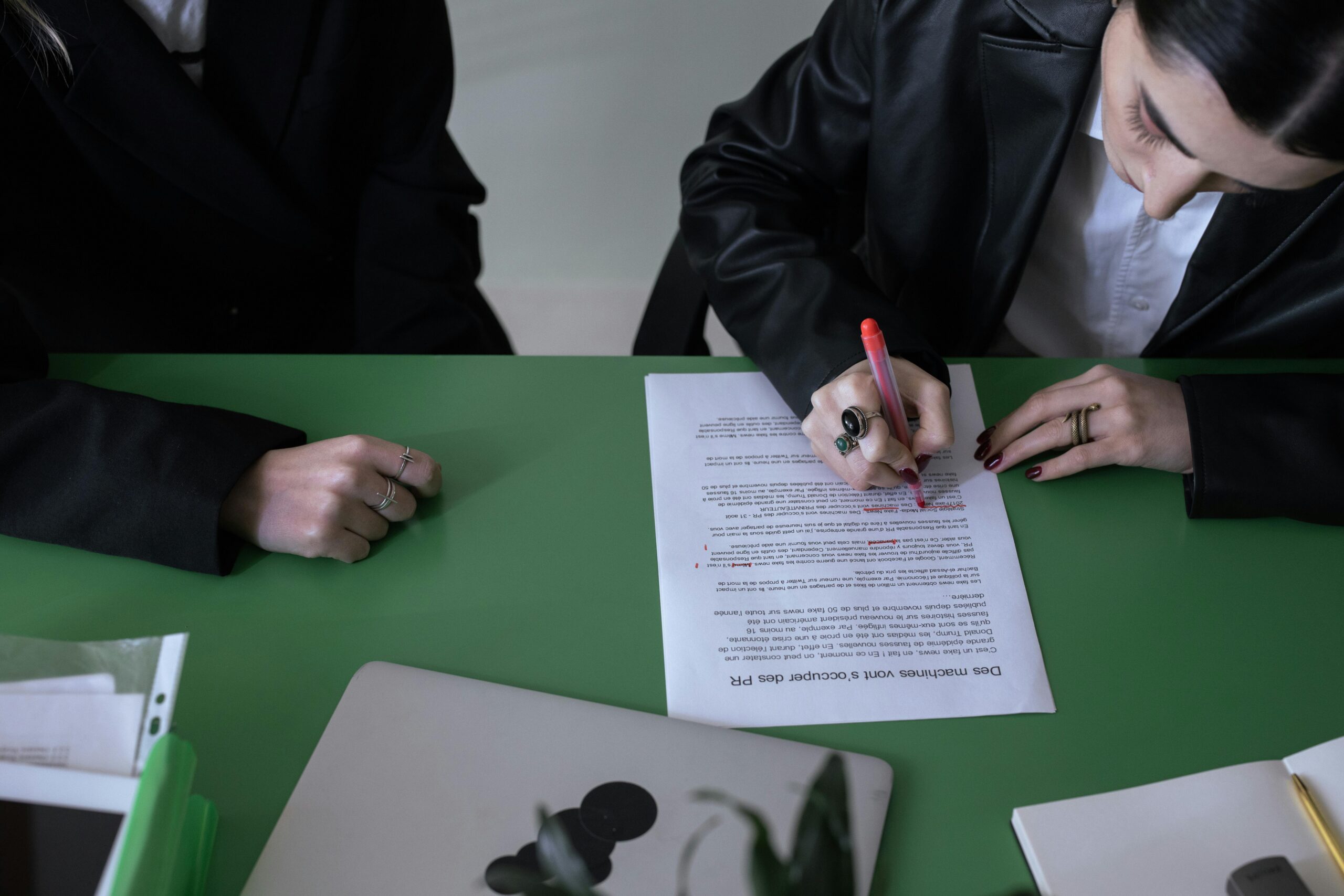 Two individuals conducting peer review of documents.