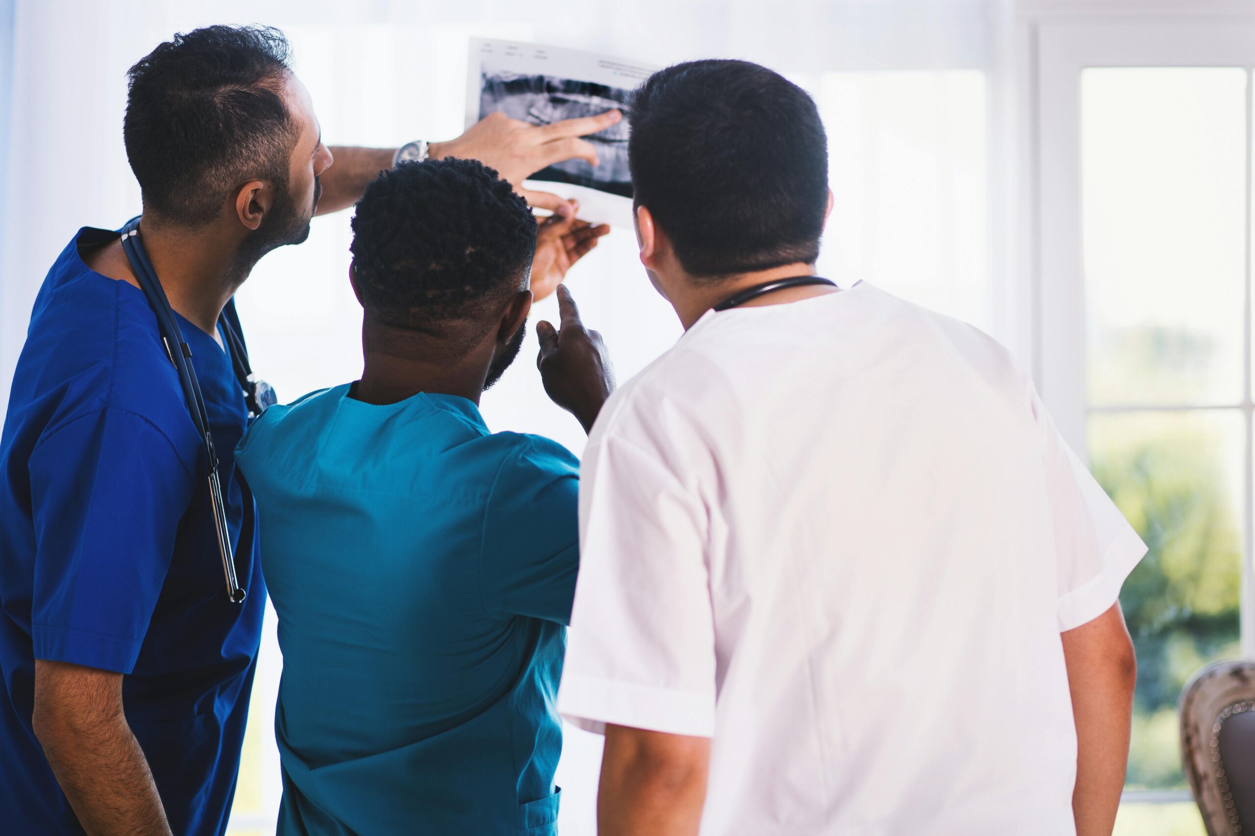 Medical professionals looking at abnormal results. Failure to escalate could make them responsibility for injury.