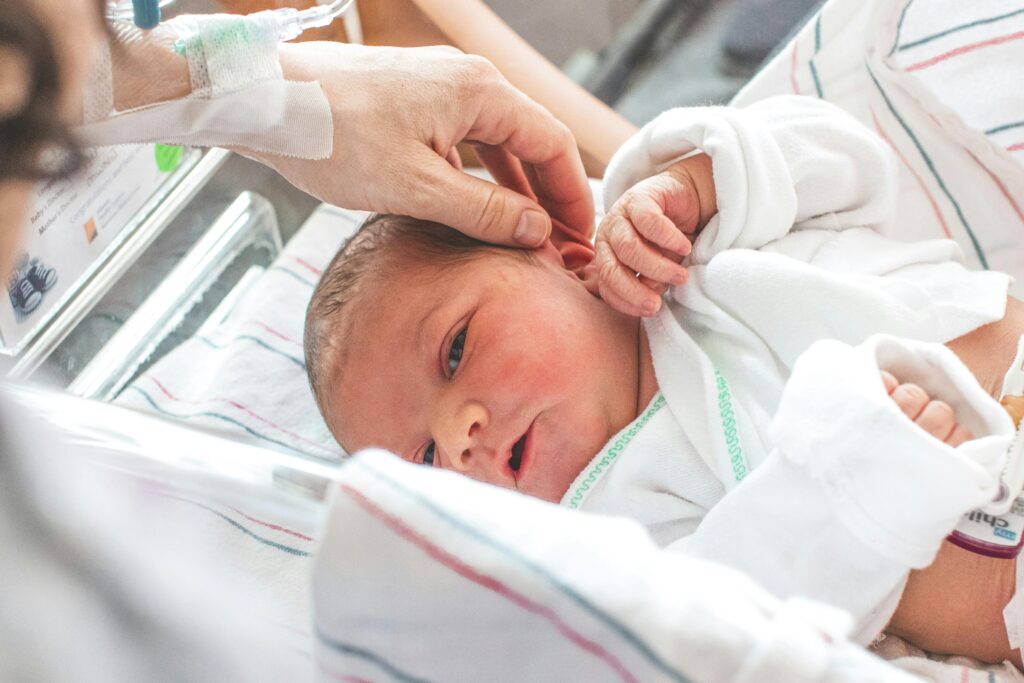 A prolonged second stage of labor can be hard on babies. Imagine shows a newborn in a hospital bed.