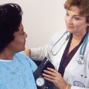 A doctor caring for an older female patient. In medical cases with multi-factor injury, it is essential to consider every avenue of how harm may have occurred.