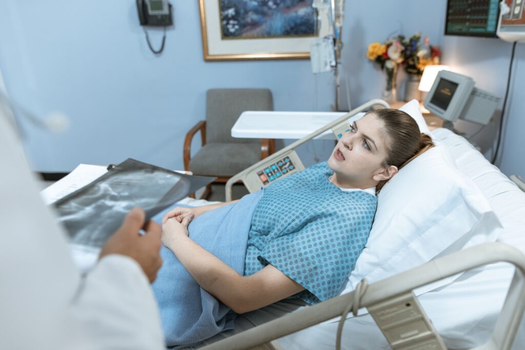 A patient laying in bed during multi-system organ failure after an injury.