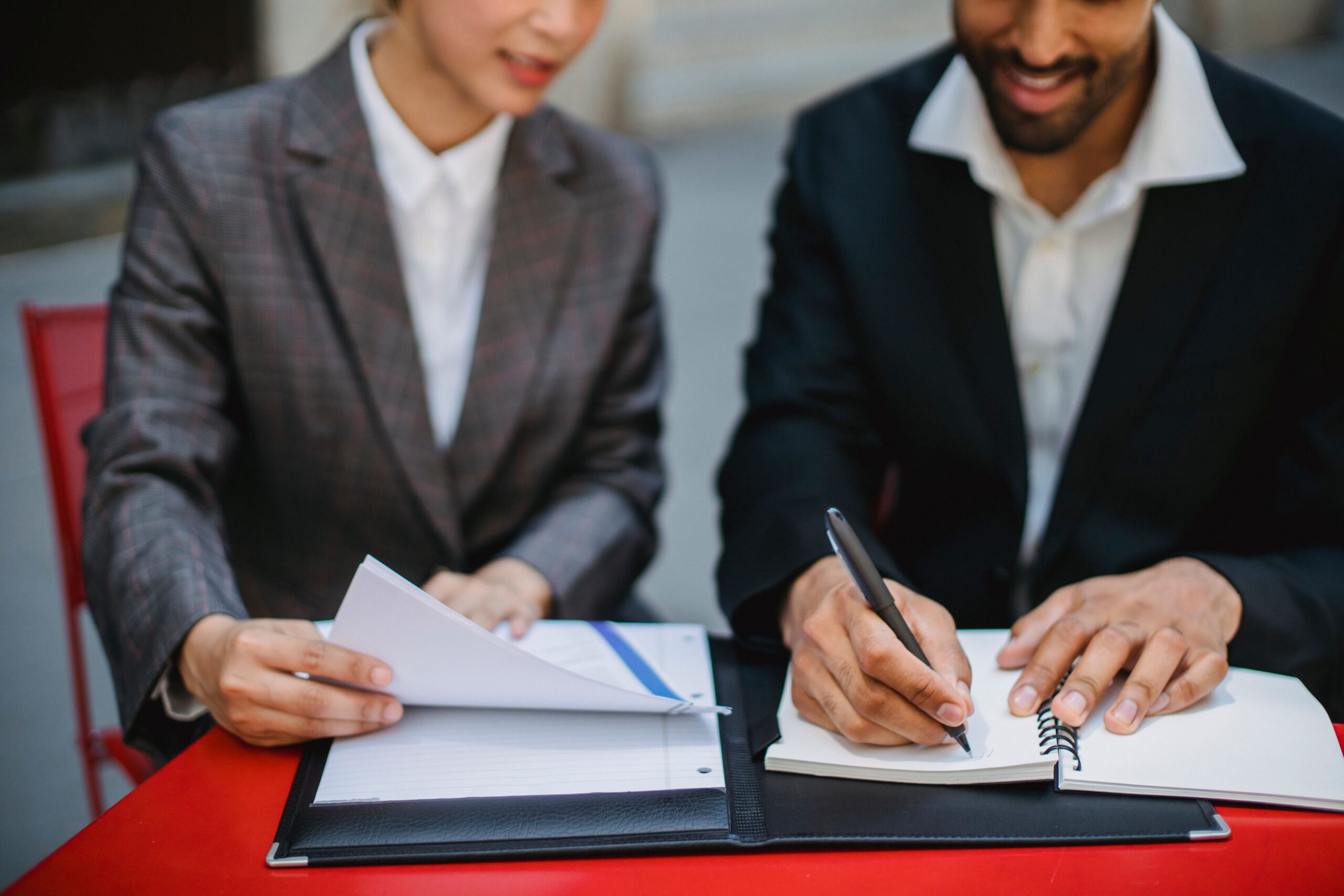Two individuals looking at documents that ensure regulatory compliance.