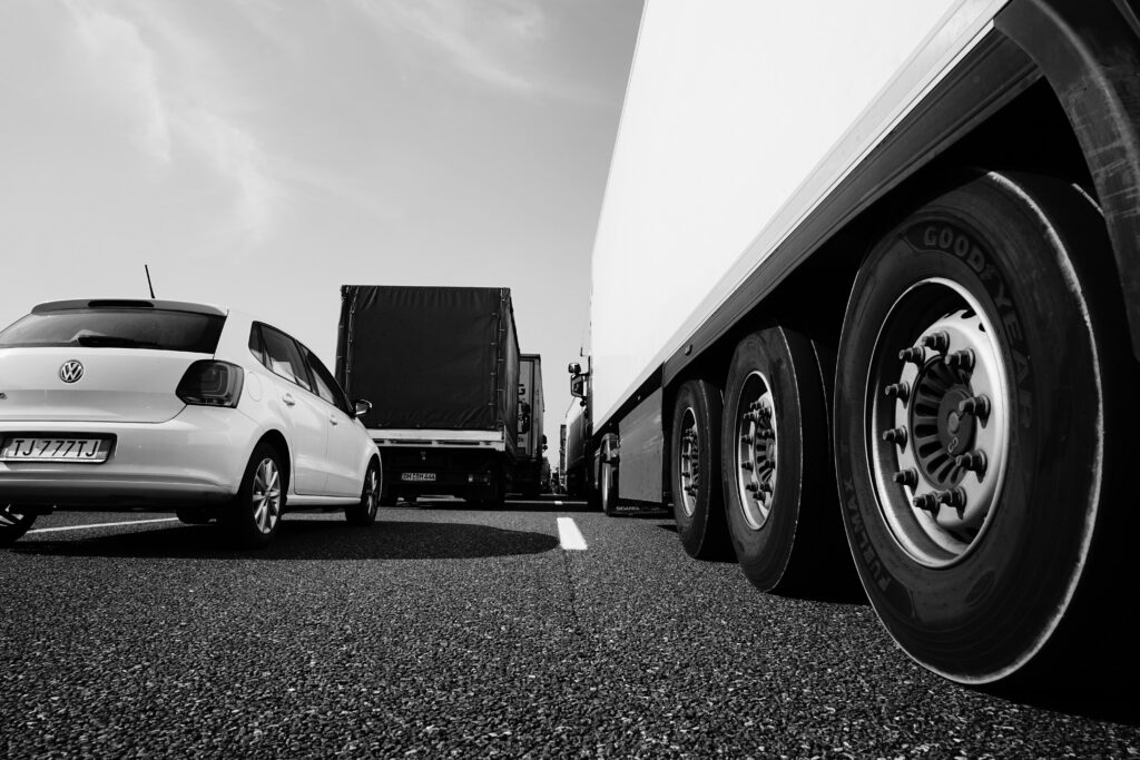 Brake failure in commercial trucking can lead to severe collisions that result in permanent injuries for the victims. Image shows a commercial truck next to a passenger vehicle.