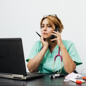 A stressed doctor at a computer who has been unable to recognize compartment syndrome.