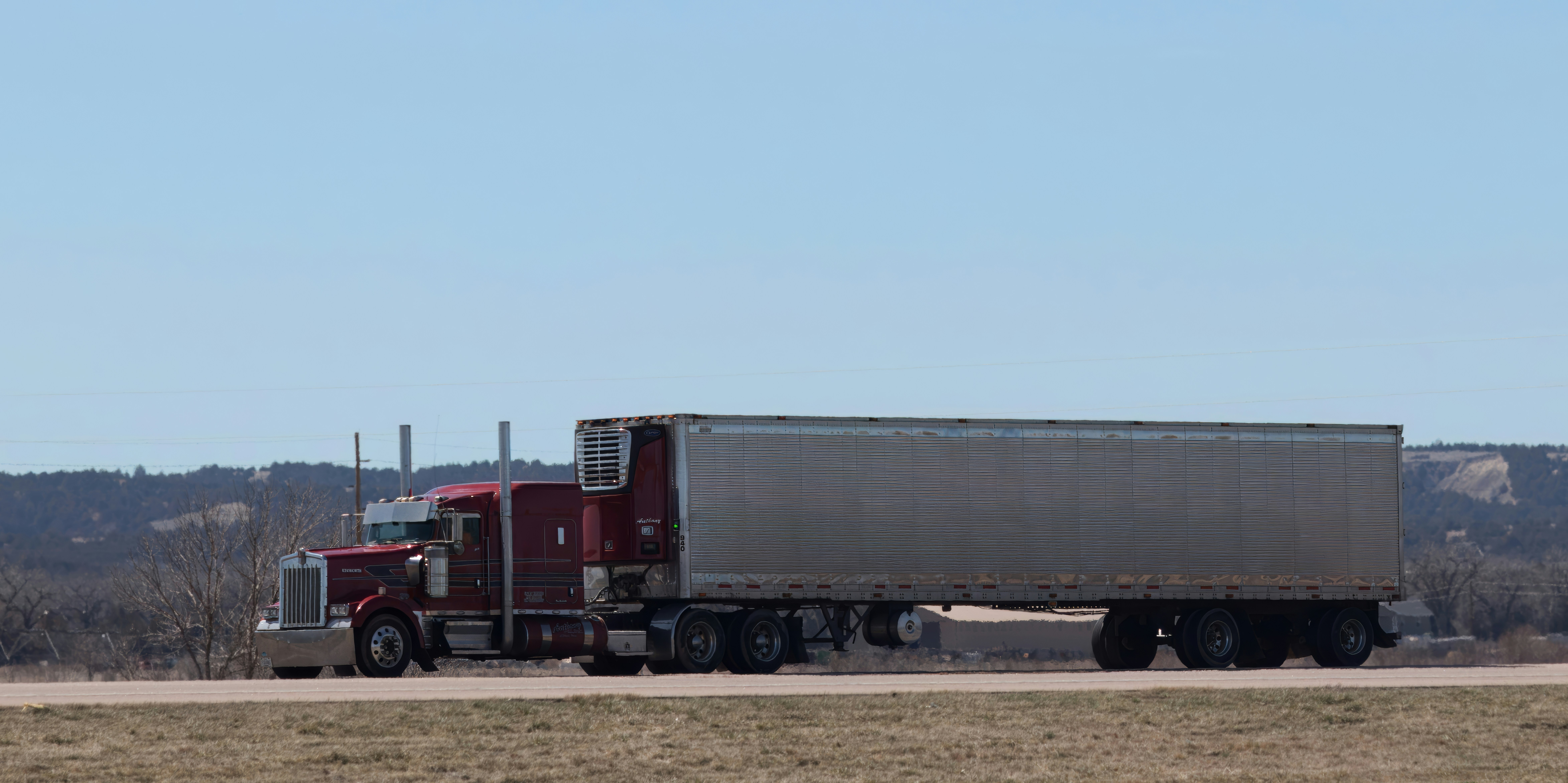 A large tractor trailer on a highway. In a truck accident, any violations on this truck may be included in punitive damages against the driver or the company.