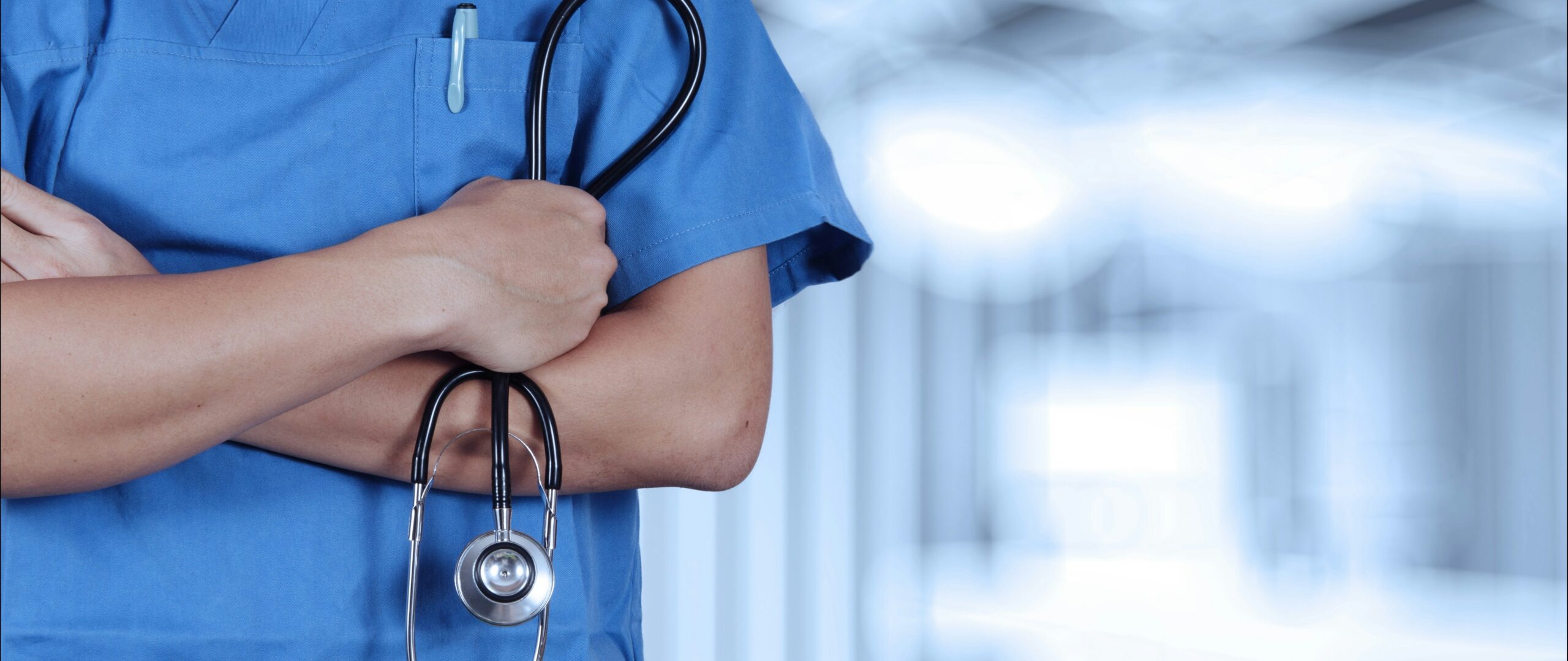 A medical professional holding a stethoscope with crossed arms. In cases where negligence leads to another injury, the care team may face consequences.